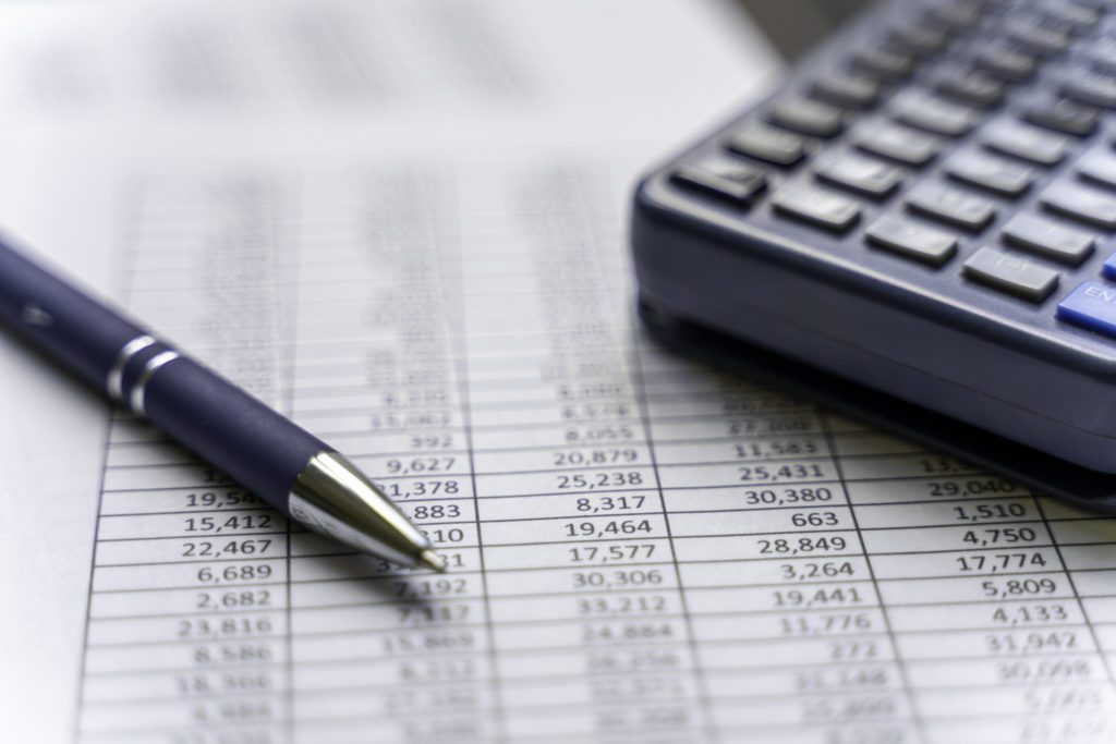 Accounting table with pen and calculator